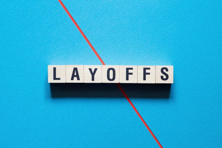 Layoffs" word on blue background with red line.