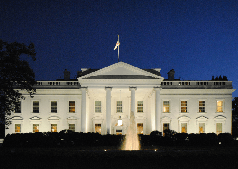 White House illuminated at night with fountain