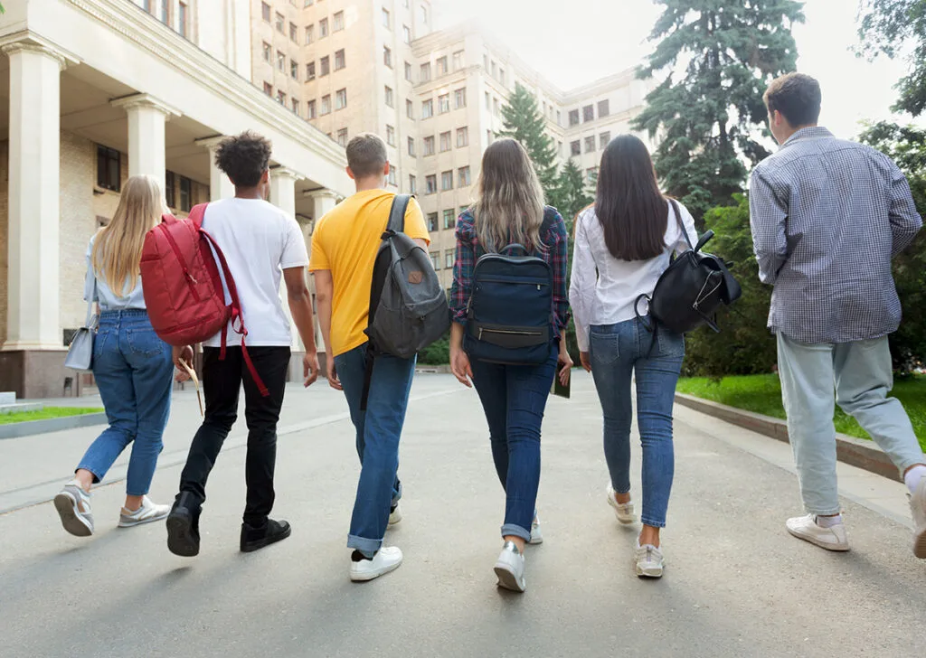 Group of students walking towards university building